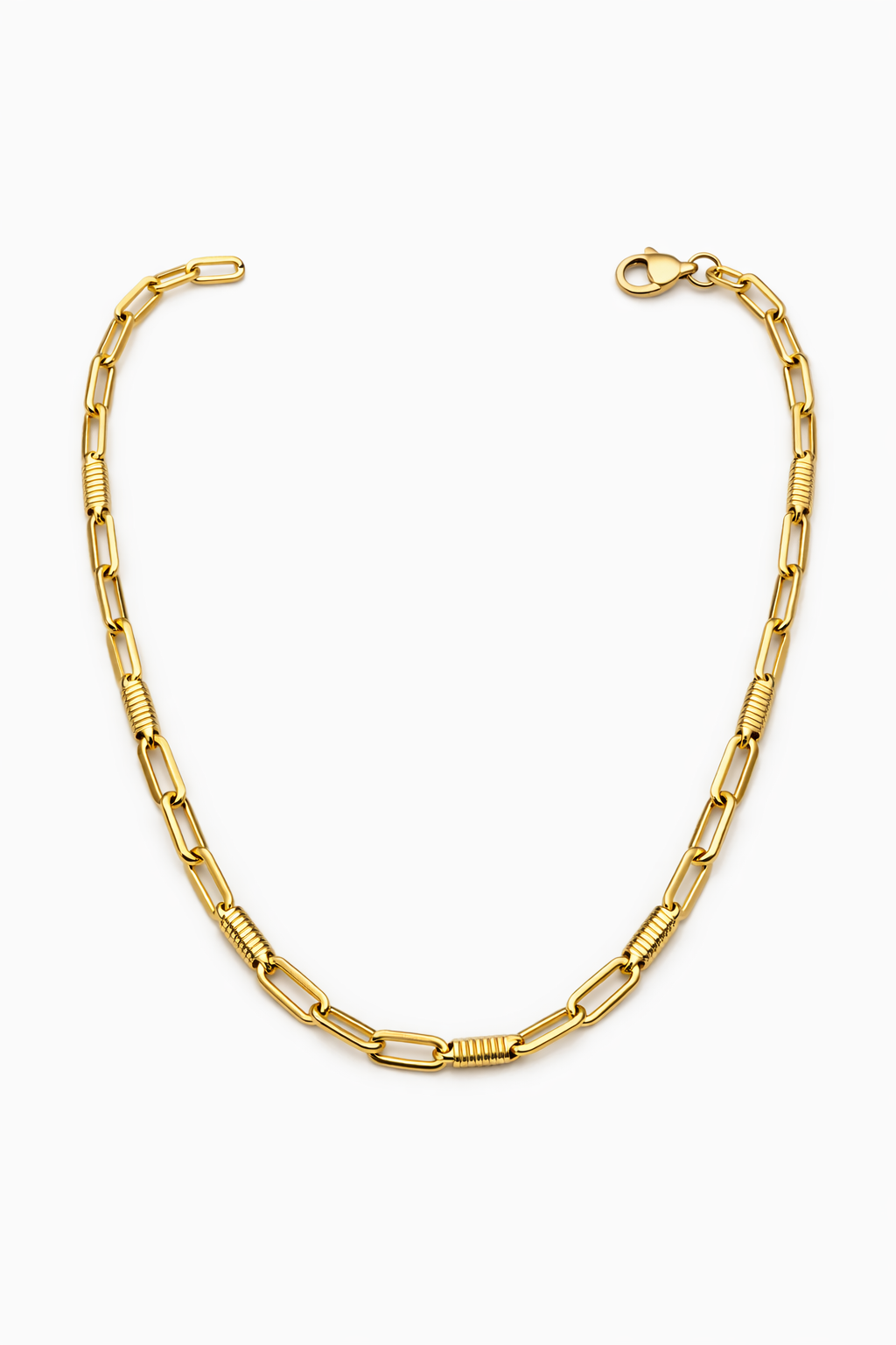 A gold chain necklace with elongated oval links and textured barrel links, displayed on a clean white background.