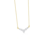 A delicate gold chain necklace featuring a curved, V-shaped pendant adorned with small clear gemstones in a silver-toned setting, displayed against a solid white background.