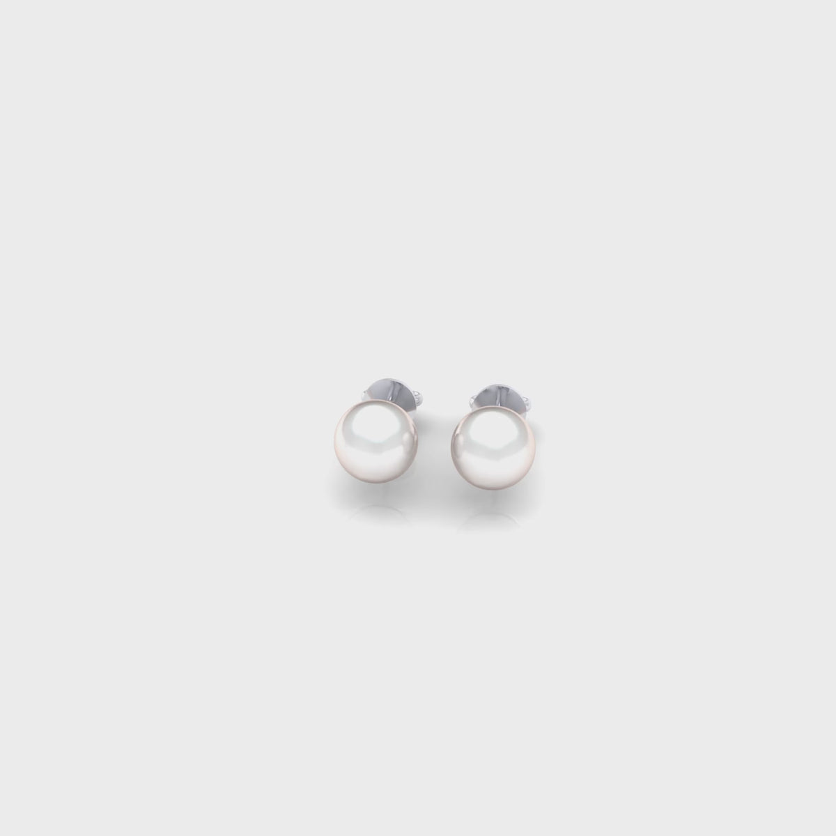 Classic pearl stud earring set in polished 14K white gold, finished with a secure butterfly pushback closure for comfortable everyday wear.